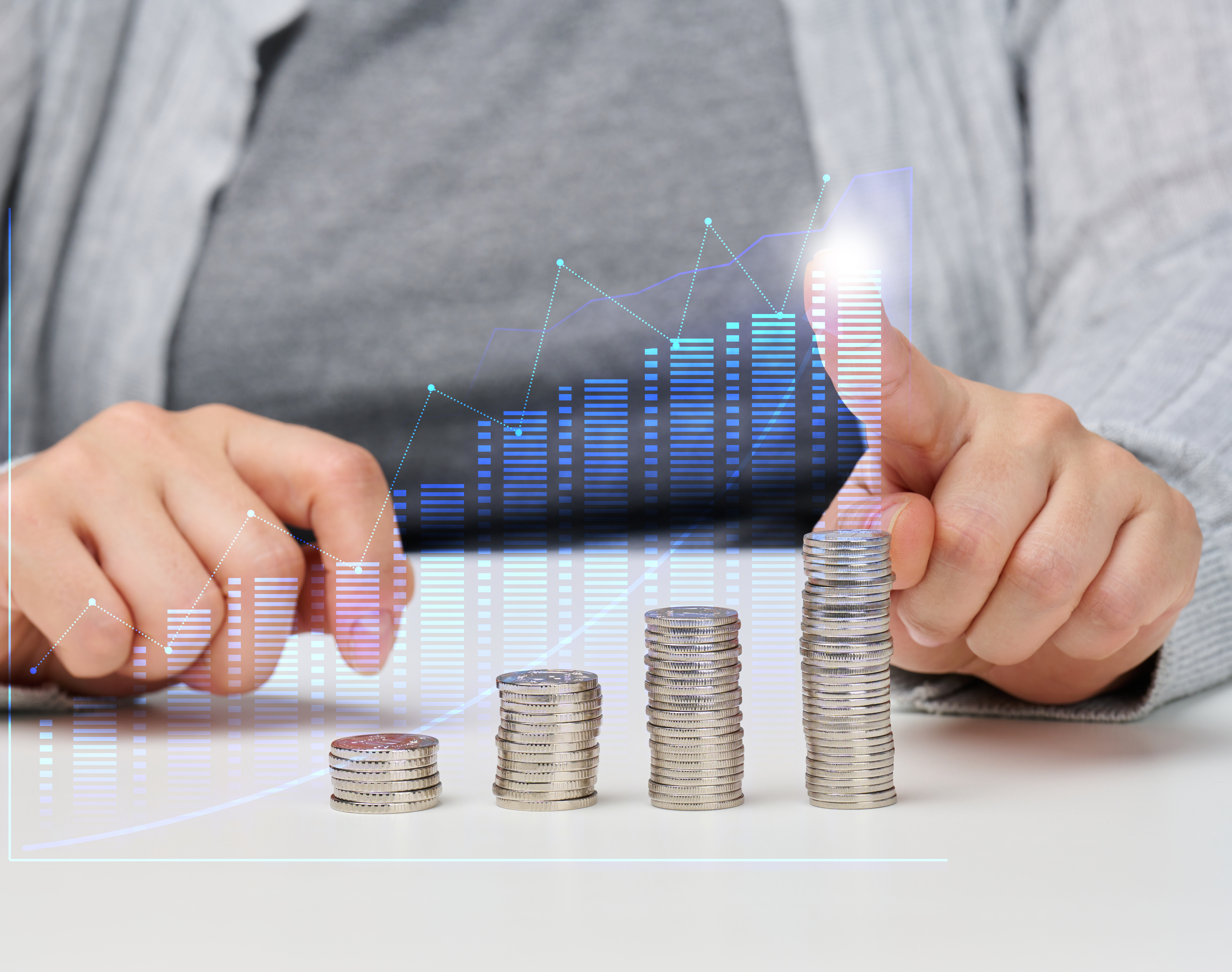 a stack of iron coins and a graph with rising indicators. Business growth concept, success. High income